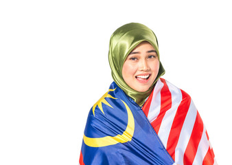 Hijab teenager holding malaysia flag for independence day celebration.