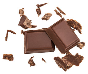 Milk chocolate pieces isolated on white background from top view