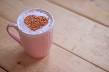 A cup of coffee with a pattern of cinnamon Valentine's Day. Holiday lovers.