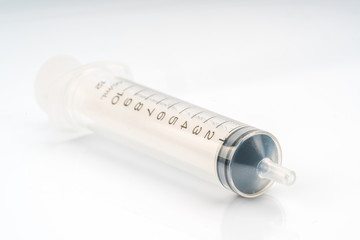 Medical syringe with white background.