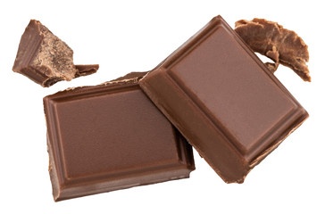 Milk chocolate pieces isolated on white background from top view