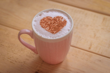 A cup of coffee with a pattern of cinnamon Valentine's Day. Holiday lovers.