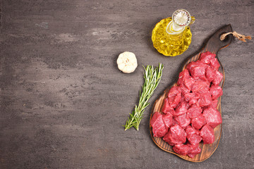 Ingredients for goulash. Raw beef meat and spices laid out on the table.