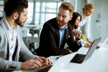 Group of business people sharing their ideas in the office