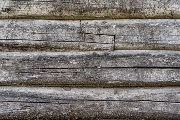 Old wooden wall from logs as a background texture. Brown rustic wooden texture background. Village house wall