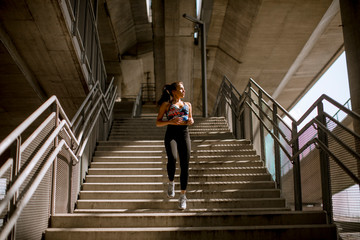 Young fitness woman doing exercises outdoor