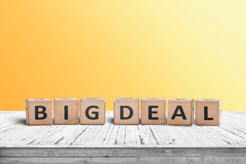 Big deal sign made of wooden cubes on a desk