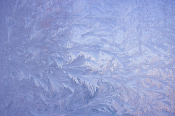 Fototapeta na wymiar Cold frost patterns on glass