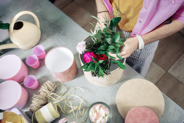 Top view of florist that composing bouquet