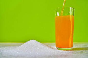 soda can pouring a crazy amount of sugar in metaphor of sugar content of a refresh drink isolated on зеленому background in healthy nutrition, diet and sweet addiction concept