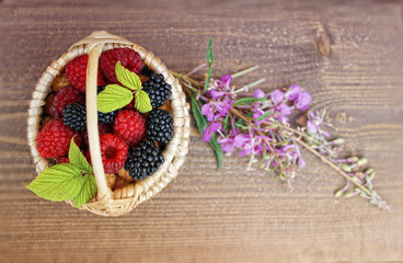 fresh  raspberries  and blackberries in little  wicker basket