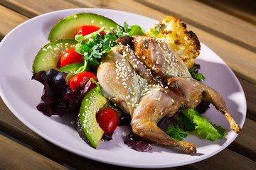 Quail-tobacco with sesame and salad of avocado is tasty dish