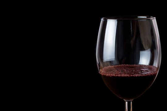 Glass of wine on a black background close-up