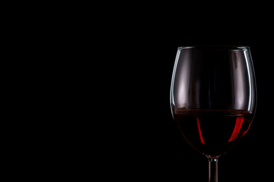 Glass of wine close up on a black background