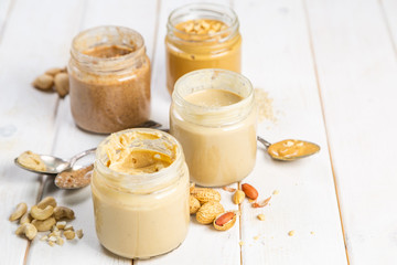 Selection of nut butters - peanut, cashew, almond and sesame seeds, copy space