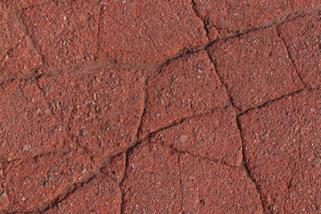 abstract background: cracked red asphalt pavement