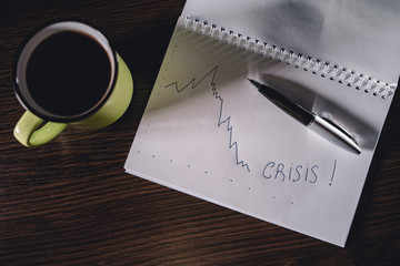 Workplace, Man working on the notebook. Inscription Crisis