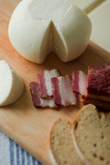 home-made cheese smoked meat and fresh bread on a dining table