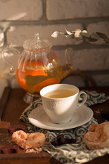 fragrant home-made pastries with hot tea on a wooden tray