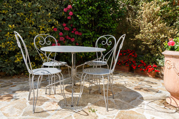 Flowered terrace with garden furnitures