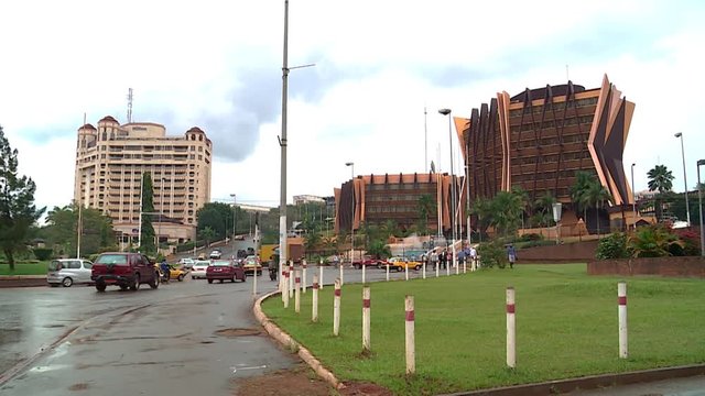 Car traffic on a roundabout of Yaound&radic;&copy; with a perspective view of the city, Cameroon.