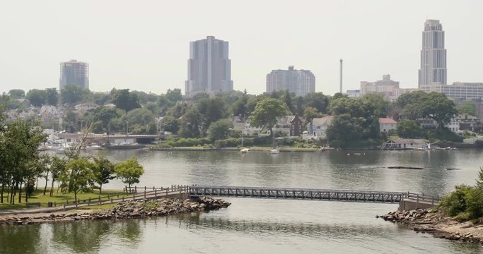 Aerial Panning Shot of a Bridge Over Water in a Small City