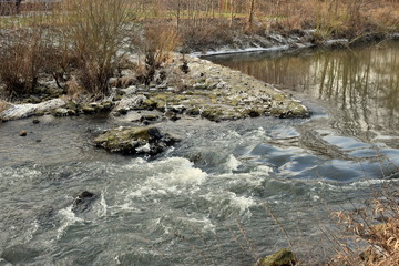 Landscape of the river and forests.Mountain river water source.Ice and first snow.