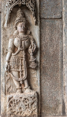 Belur, Karnataka, India - November 2, 2013: Chennakeshava Temple building. Brown stone sculpture of Mohini, avatar of Lord Vishnu on temple wall. 