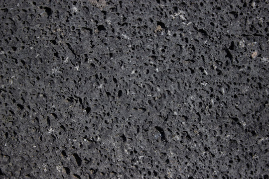 basalt wall, volcanic rock, stone with holes