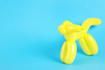 Animal figure made of modelling balloon on color background. Space for text