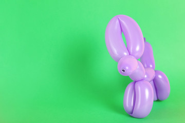 Animal figure made of modelling balloon on color background. Space for text