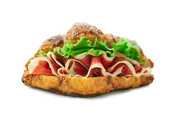 Croissant sandwich with jamon of ham and lettuce on white