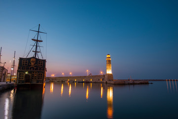 Beautiful sailboat and lighthouse at the night. Greece, Crete.