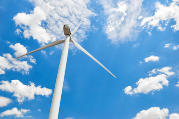 The wind generator is in bright cloudy sky. Eco energy concept.