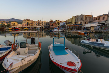 Fototapeta na wymiar Greece, Crete Rethymnon, old venetian harbor, beautiful boats at the sunset.. 