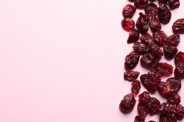 Cranberries on color background, top view with space for text. Dried fruit as healthy snack