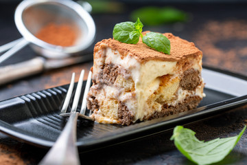Piece of homemade Italian tiramisu dessert.