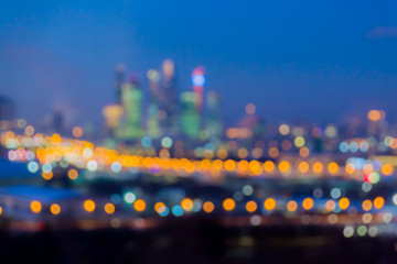 Defocused abstract image. Bokeh effect. Golden lights of the big city. Night city landscape, lights and Windows of houses.