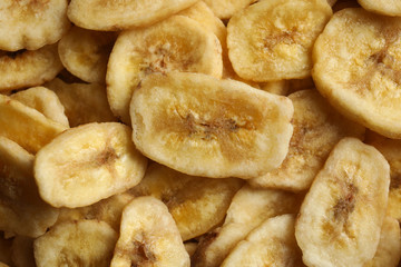 Obraz na płótnie Canvas Sweet banana slices as background, top view. Dried fruit as healthy snack