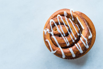 Homemade Fresh Cinnamon Roll / Bun with Cream Sauce served with Marble Board.