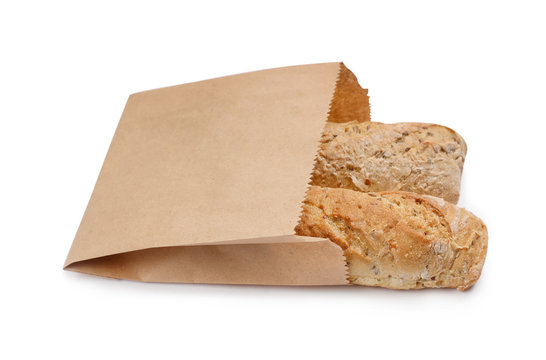 Paper bag with bread loaves on white background. Space for design