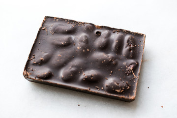 Bitter Almond Chocolate Bar on Dark Wooden Surface.