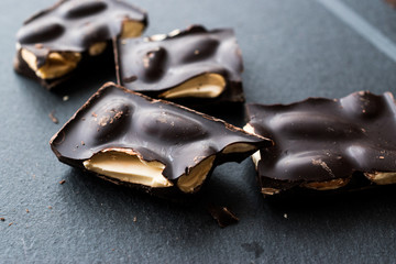 Bitter Almond Chocolate Pieces Dark Marble Surface.