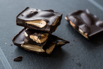 Bitter Almond Chocolate Pieces Dark Marble Surface.
