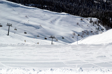 Obraz premium Skiers and snowboarders on chairlift, ski resort Rosa Khutor, Sochi Russia