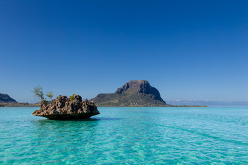 Crystal Rock im türkisfarbenen Wasser des Indischen Ozeans mit dem Berg Le Morne Brabant im Hintergrund bei Le Morne, Mauritius, Afrika.