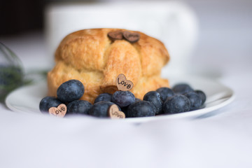 Cute Wooden Heart With Word LOVE Decorates Sweet Pastry and Fresh Berries on White Plate. Concept: Valentine's Day dessert. 