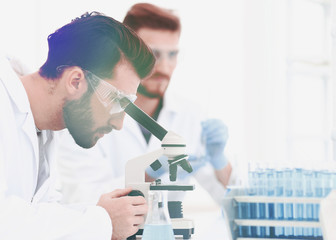biologist explores the substance under the microscope