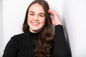 Portrait of a charming brunette little girl on white background