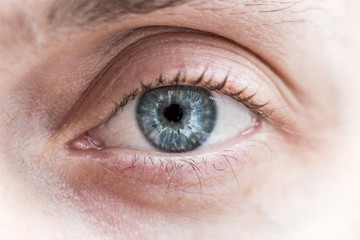 blue male eye looking into the lens